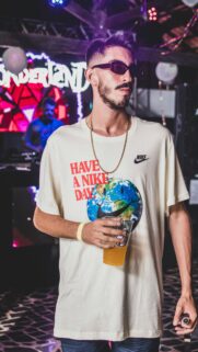 Young Man in Nike Earth Shirt at Party Night Mobile Wallpaper