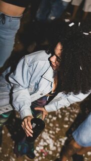 Curly Hair Girl in Denim Jacket at Festive Party Mobile Wallpaper