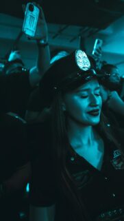 Woman in Police Costume Night Party Aesthetic Mobile Wallpaper