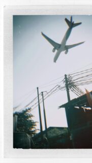 Stunning Low Flying Airplane Over Urban Neighborhood Mobile Wallpaper