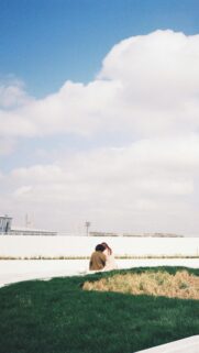 Couple Sitting Together Under Vast Blue Sky Minimalist Mobile Wallpaper