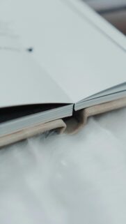 Minimalist Open Book on Soft White Fur Luxury Mobile Wallpaper