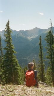 Hiker Overlooking Mountain Valley Scenic Nature View Wallpaper