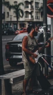 Street Musician Playing Electric Guitar Urban Vibes Mobile Wallpaper