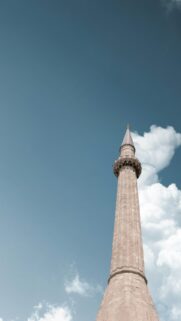 Stunning Islamic Minaret Tower Against Clear Blue Sky Wallpaper
