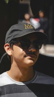 Stylish Man with Crown Cap and Sunglasses Mobile Wallpaper