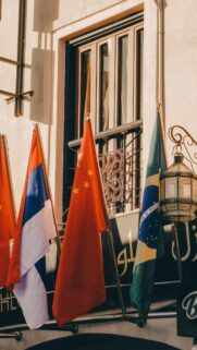 Patriotic Global Flags Outside Rustic Building Mobile Wallpaper