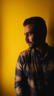 Stylish Man Profile Portrait with Vibrant Yellow Background Wallpaper