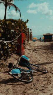 Abandoned Blue Bicycle on Sandy Beach Coastal Summer Vibes Wallpaper