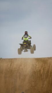 Thrilling ATV Quad Bike Mid-Air Jump Racing Mobile Wallpaper