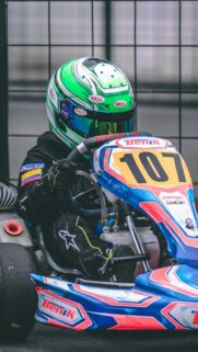 Young Kart Racer with Green Helmet Number 107 Wallpaper