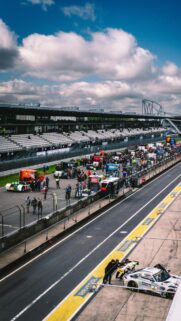 High-Octane Nürburgring Pit Lane Action Mobile Wallpaper