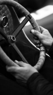Vintage Race Car Steering Wheel Driver Hands Black and White Wallpaper