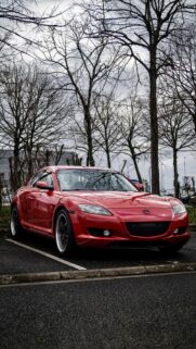 Red Mazda RX-8 Sports Car Parked Under Winter Trees Mobile Wallpaper