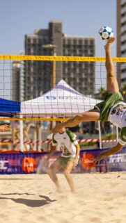 Dynamic Footvolley Spike on Sandy Beach Mobile Wallpaper