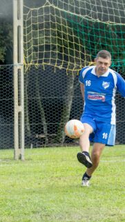Action Soccer Player in Blue Jersey Striking the Ball Wallpaper