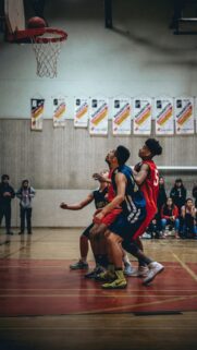 Intense Basketball Players Under the Hoop Action Wallpaper