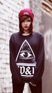 Edgy Girl with Burgundy Beanie and Illuminati Sweatshirt Wallpaper