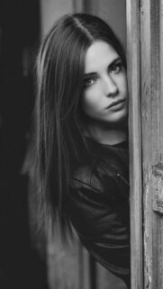 Beautiful Woman Peeking Through Door Black and White Portrait Wallpaper