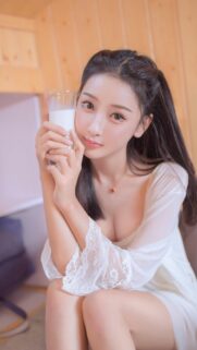 Beautiful Young Asian Woman Holding a Glass of Milk High Resolution Wallpaper
