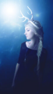 Ethereal Fantasy Woman with Deer Antlers in Magical Blue Light Wallpaper