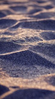 Macro Beach Sand Texture with Warm Sunset Glow Mobile Wallpaper