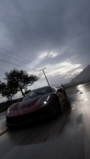 Red Ferrari Sports Car Driving on Wet Rainy Road Mobile Wallpaper