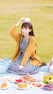 Cute Girl Having a Picnic with Fresh Fruits and Bread Mobile Wallpaper