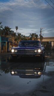 Classic Blue Chevrolet Impala Street Scene Wallpaper