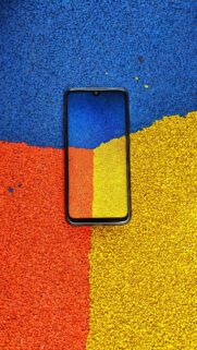 Vibrant Multicolored Textured Background With Smartphone Display Wallpaper