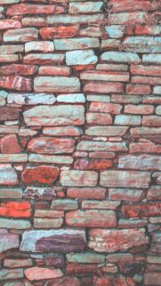Rustic Stone Wall Texture Background with Vibrant Earthy Tones and Vintage Aesthetic