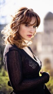 Stunning Portrait of a Woman with Freckles and Auburn Hair Mobile Wallpaper