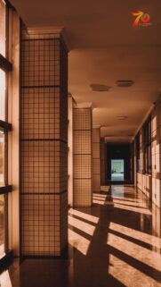 Sunlit Corridor Aesthetic Wallpaper With Tiled Pillars and Warm Shadows for Mobile