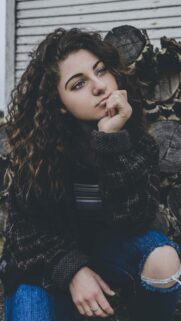 Pensive Curly Hair Girl With Blue Eyes High Quality Mobile Wallpaper