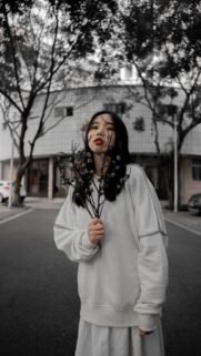 Aesthetic Portrait of a Girl Holding Dried Flowers Wallpaper