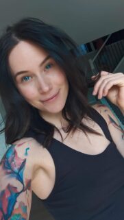 Beautiful Young Woman with Vibrant Colorful Tattoos and Piercings Portrait Wallpaper