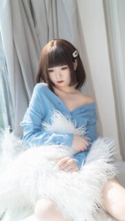 Beautiful Girl in Blue Sweater with Fluffy Pillow Wallpaper for Mobile