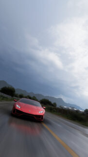 Stunning Red Lamborghini Huracan Speeding on Wet Asphalt Mobile Wallpaper