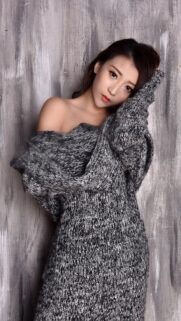 Beautiful Asian Woman in Cozy Grey Knit Sweater Mobile Wallpaper