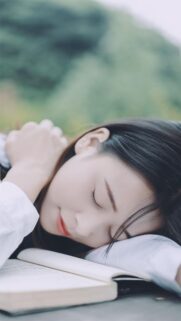Peaceful Girl Sleeping on an Open Book Aesthetic Mobile Wallpaper