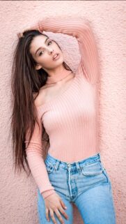 Beautiful Young Woman in Pink Ribbed Top and Blue Jeans Mobile Wallpaper