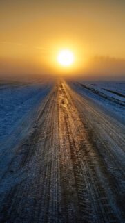 Golden Sunrise Over Snowy Winter Road Mobile Wallpaper Background