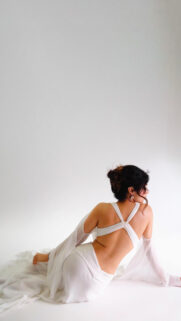 Elegant Woman in White Dress Studio Portrait Minimalist Wallpaper