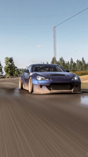 Stunning Blue Modified Sports Car Driving on Scenic Road Wallpaper