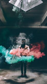 Edgy Streetwear Portrait with Vibrant Green and Red Smoke Effects Wallpaper