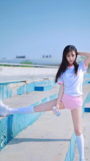 Beautiful Asian Girl Doing Stretching Exercises at Sports Track Wallpaper