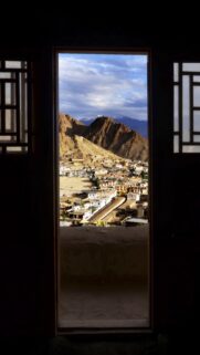 Stunning Himalayan Town View Through an Ancient Window Frame Wallpaper