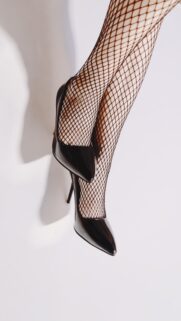 Elegant Legs in Fishnet Stockings and Black Stiletto Heels Wallpaper