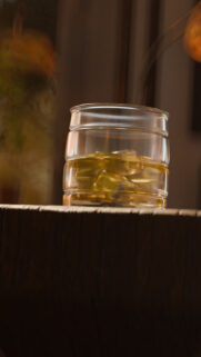 Elegant Whiskey Glass on Rustic Wood Surface Mobile Wallpaper