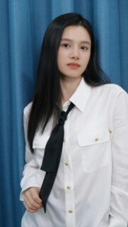 Stunning Portrait of a Young Woman in a White Shirt and Black Tie Wallpaper